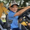 Kid on construction equipment at Dig World Texas
